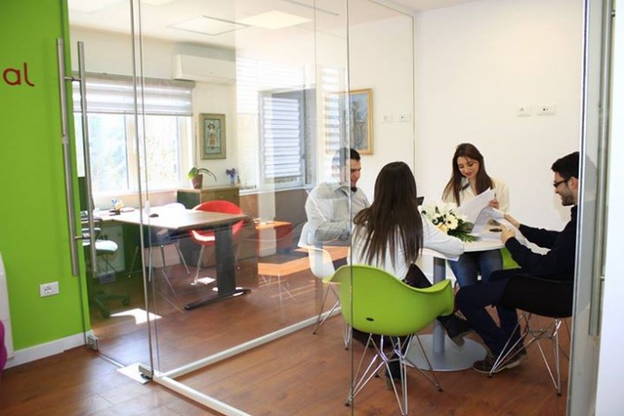 Glass-walled meeting room in use